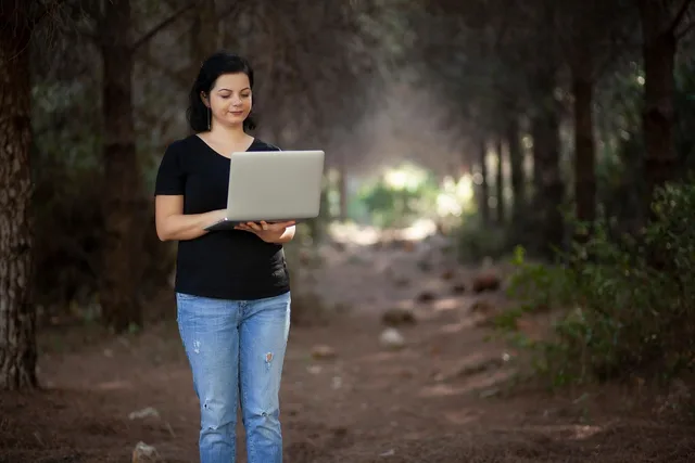 woman, work, laptop, computer, electronic, freelance, nature, forest. Influencer agency vs freelancer: which is right for your UK brand?
